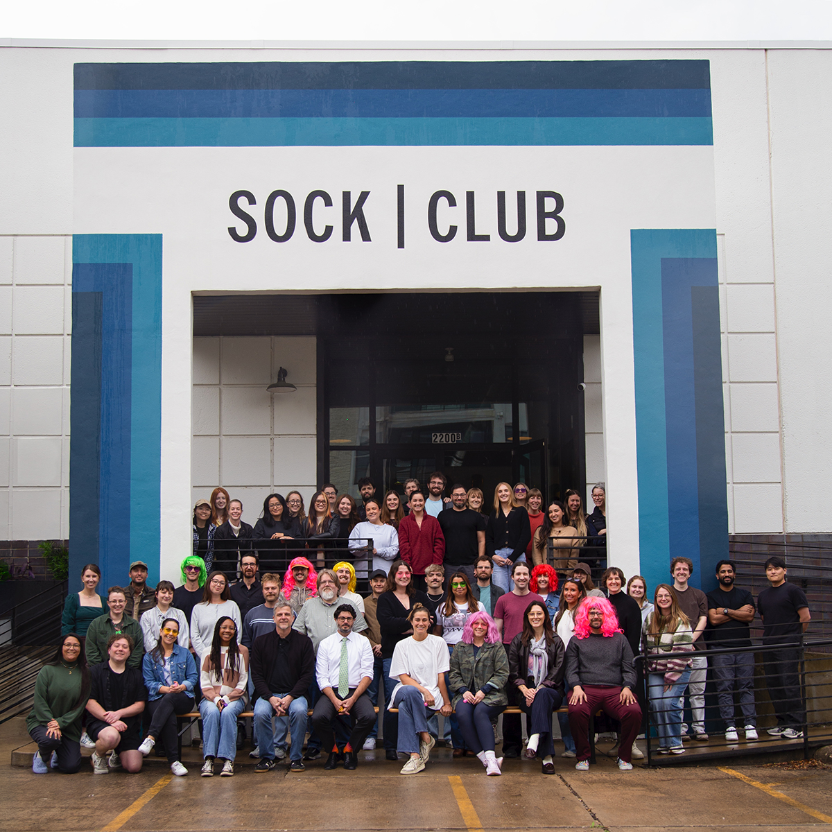 The Sock Club team at a trade show or event wearing matching black shirts and badges