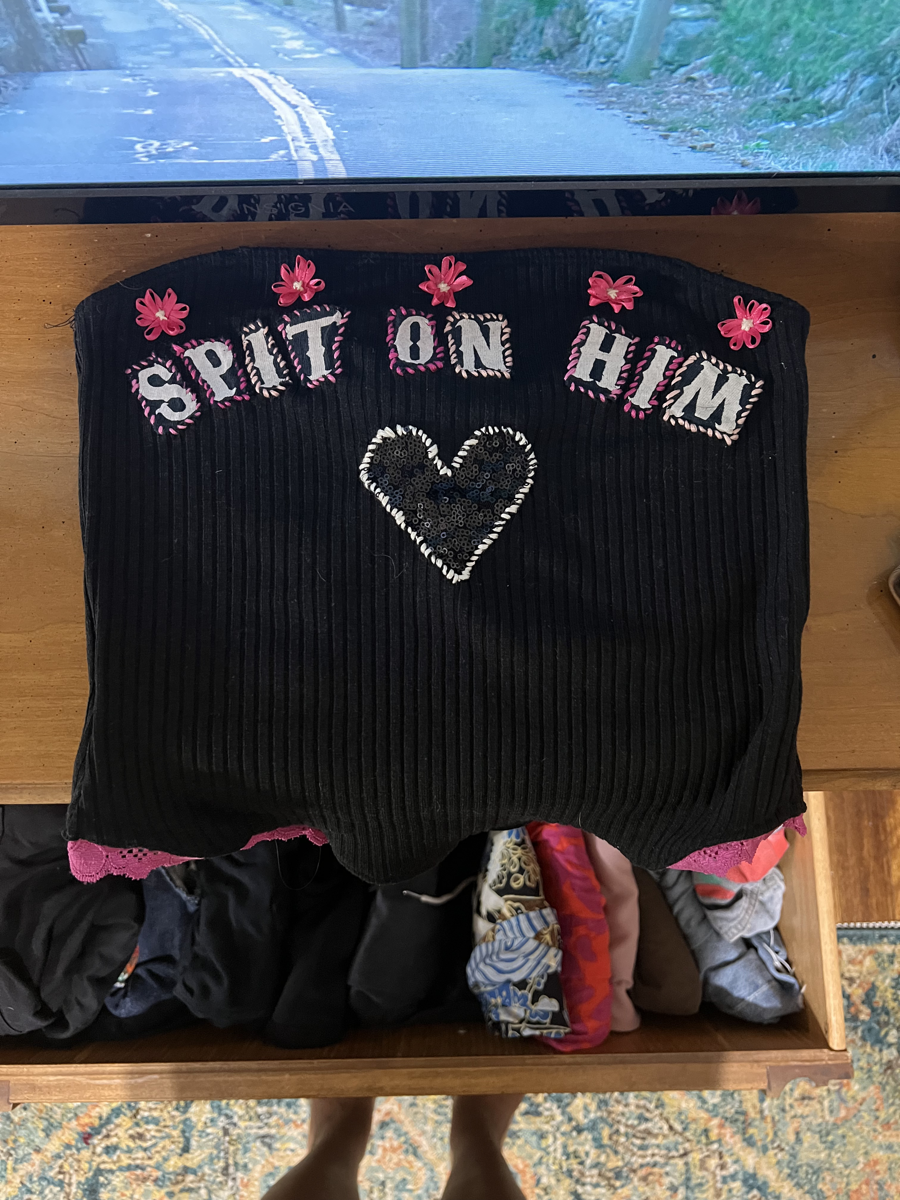 completed tub top embroidered, detailed with ribbon flowers, and a sequin heart, using collaged letters to spell "spit on him"