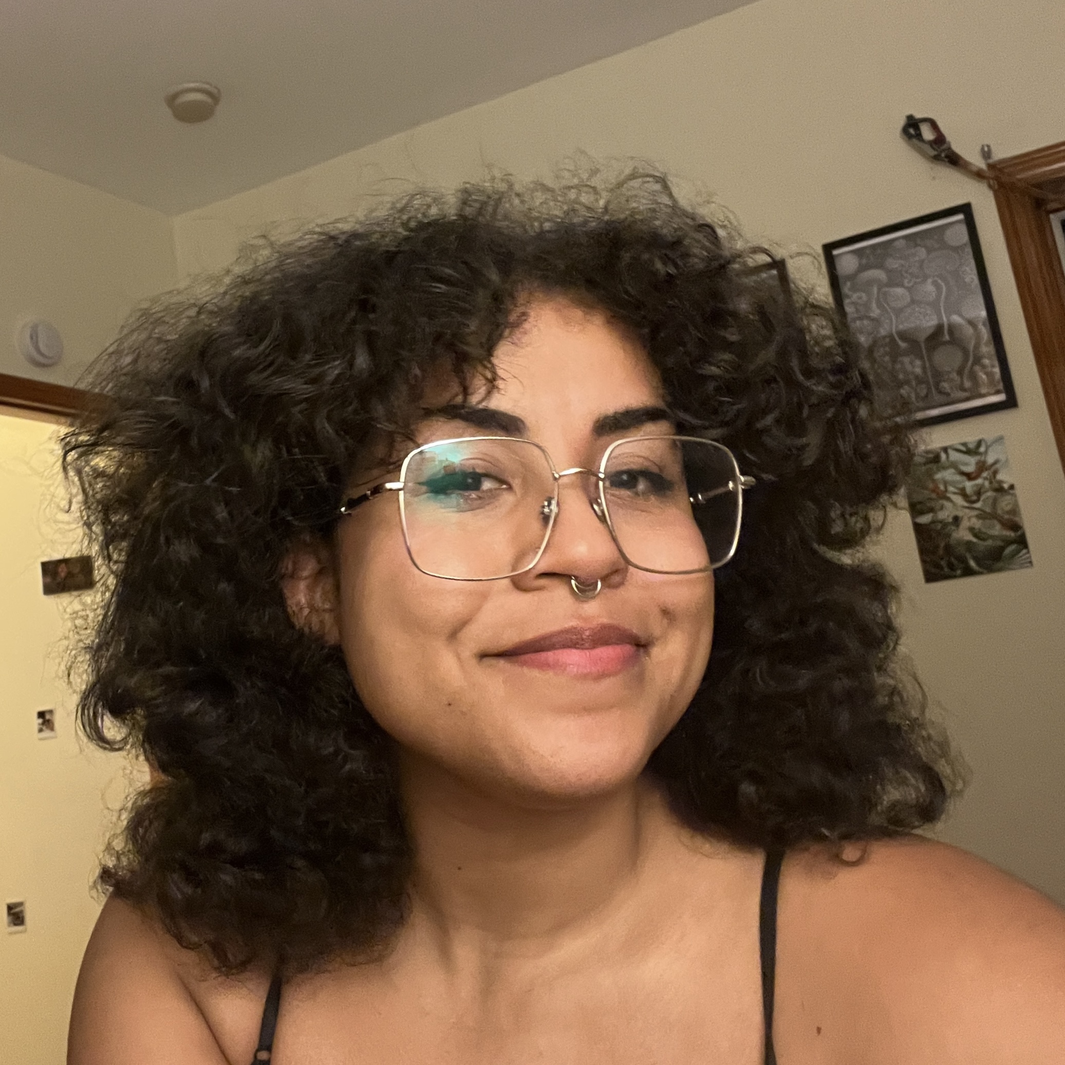 aaliyah smiling with glasses on and natural hair