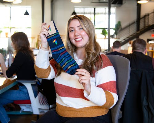 employee appreciation gifts with woman holding custom socks with logo