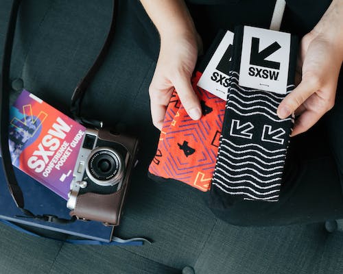 custom socks with logo of SXSW in black and orange for events with camera 