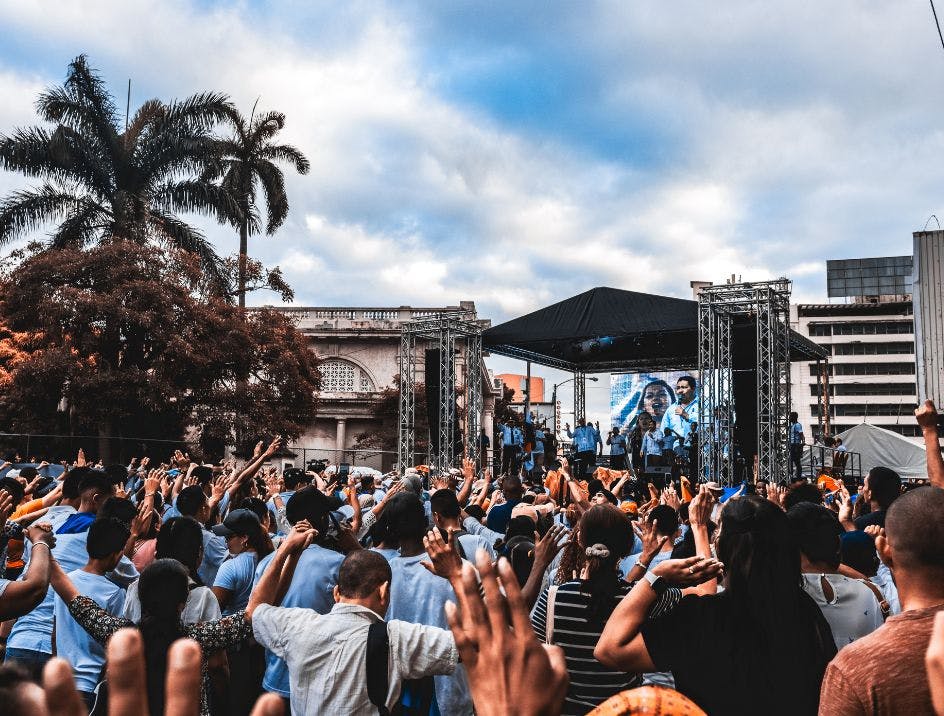 A crowd of people at a music festival outside