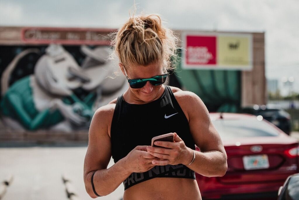 Image of Jessica Cahoy looking at her phone outdoors.