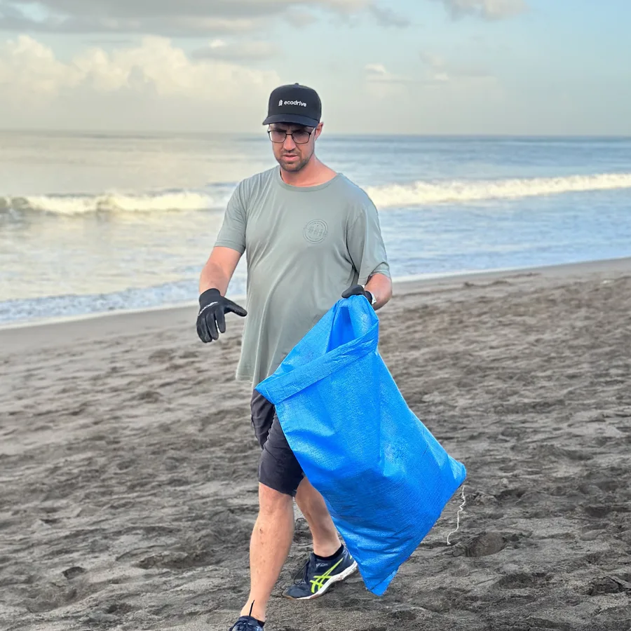Sukin ocean cleanup volunteer collecting plastic on a beach