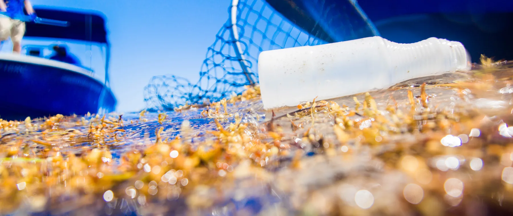 Ocean cleanup crew collecting plastic waste from the water
