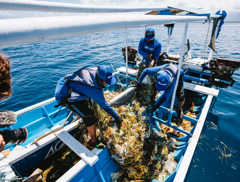Crew removing plastic from a coastline