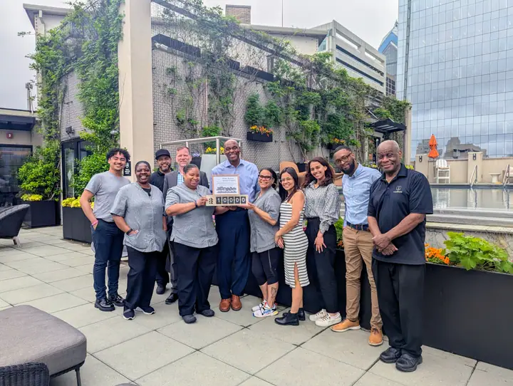 Burnell Goldman and The Windsor Suites team celebrating their tree-planting impact
