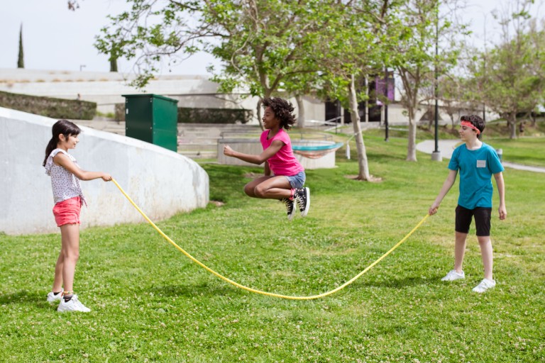 Children playing outdoors to support healthy vision and reduce the risk of developing myopia