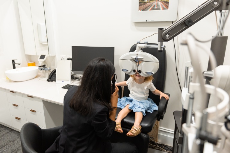 Optometrist checking a young child’s prescription during a myopia assessment at Innovative Eye Care