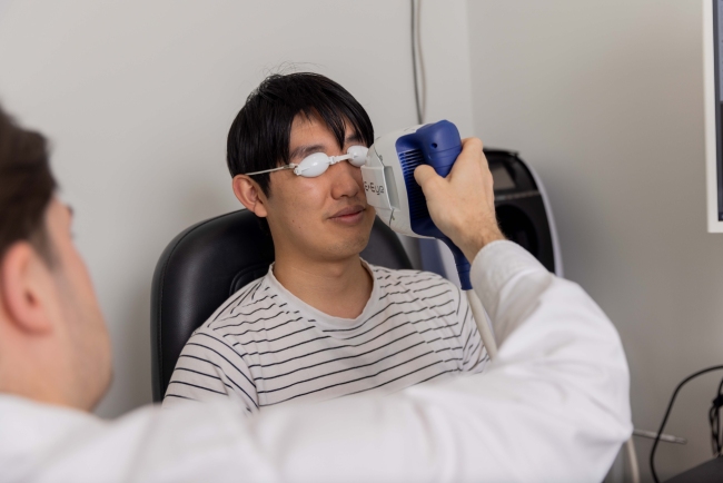 Patient receiving intense pulsed light treatment around the eyes for dry eye