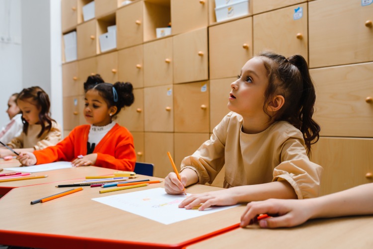 Children drawing and learning together in a classroom
