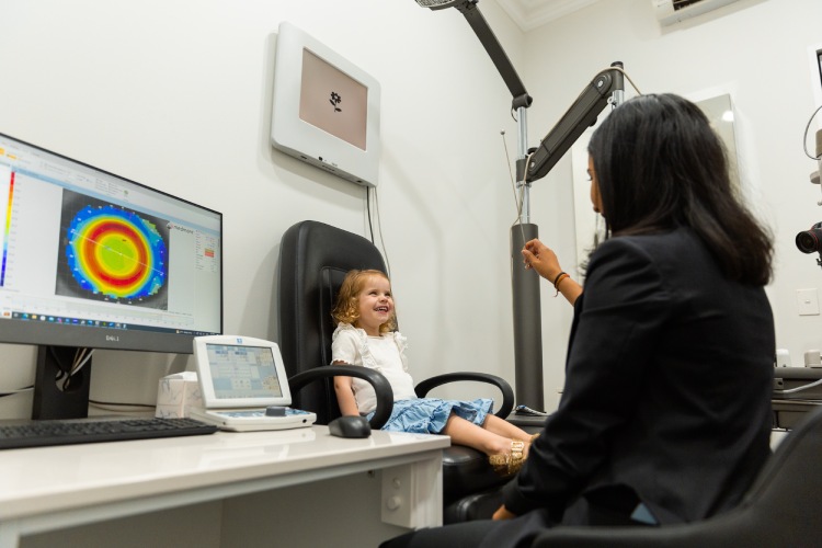 Optometrist assessing a young child’s eye movements and coordination during an eye test