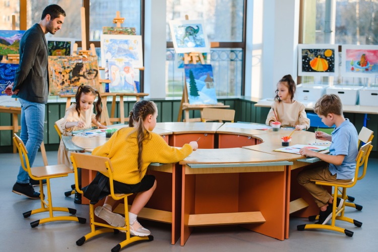 Primary school children completing art activities in a classroom