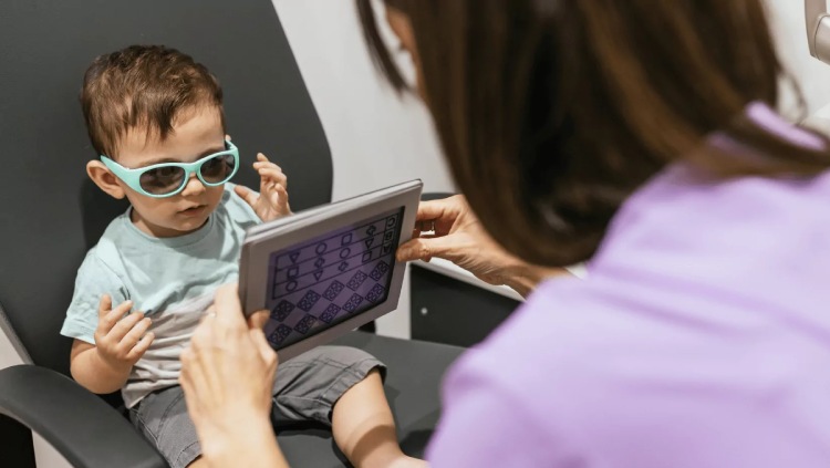 Young child completing a detailed vision assessment with an optometrist using a picture chart