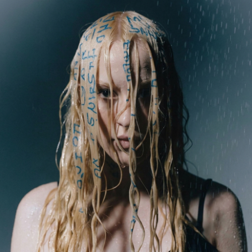 Portrait of a person with wet blonde hair and blue handwriting on their face in the rain, made with Recraft