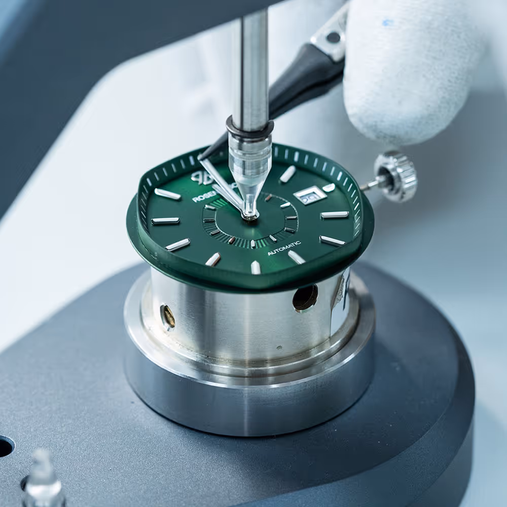 Montage einer Rosenbusch-Uhr in der Uhrenmanufaktur – Handwerkliche Präzision in der Fertigung.