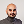 Portrait of a bald man with a beard wearing a gray turtleneck sweater against a plain light background.