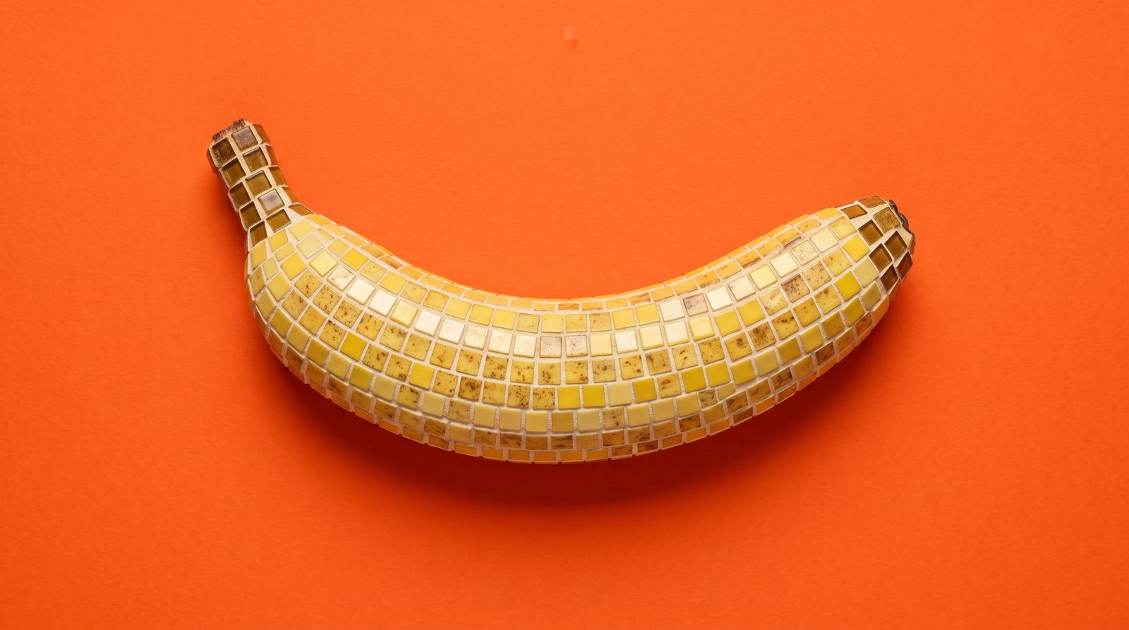 Mosaic banana on an orange background, cover for Nano Banana 2.1 in Recraft Studio