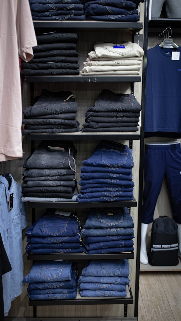 a rack of blue jeans in a store