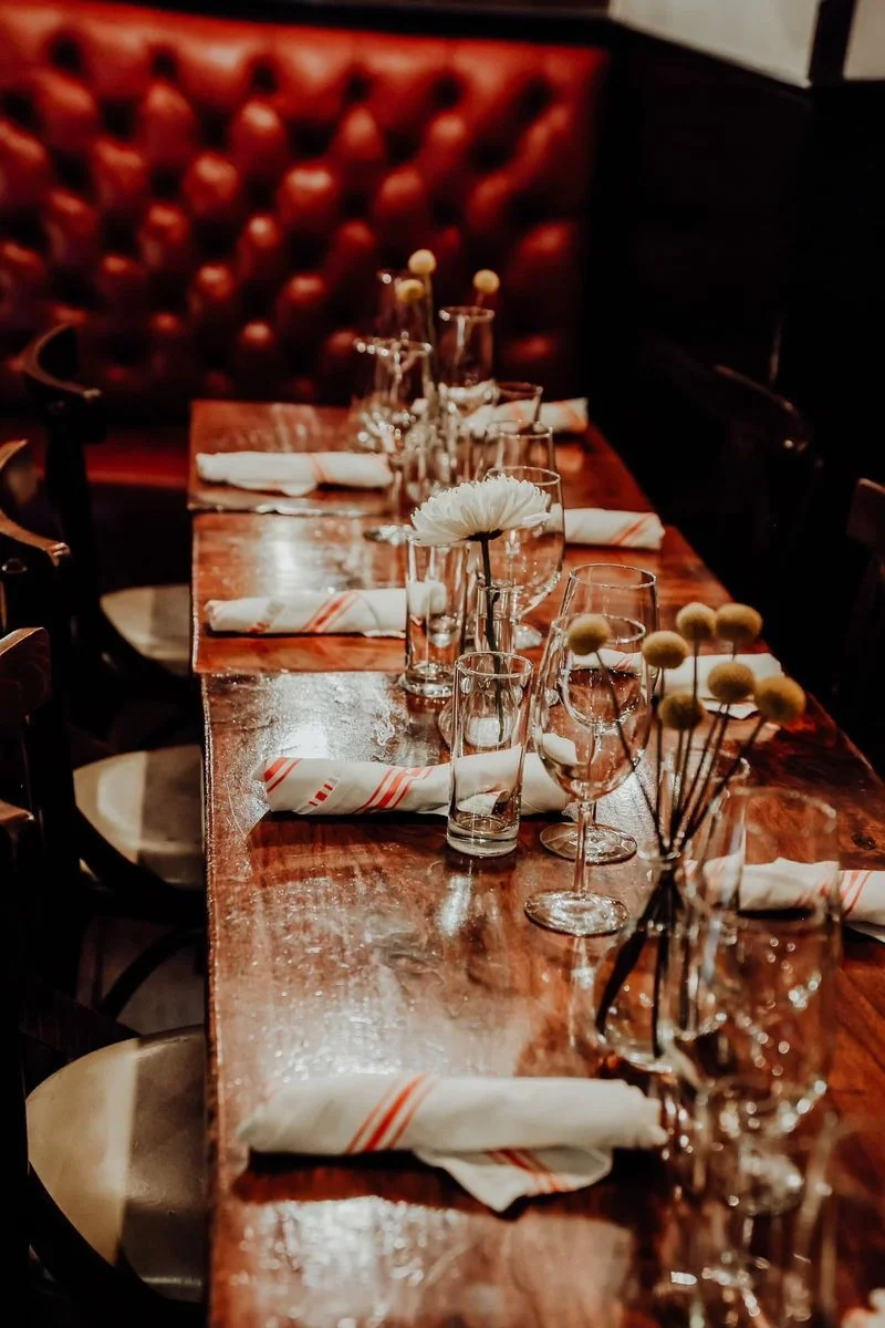 Long dinner table in dimly lit setting