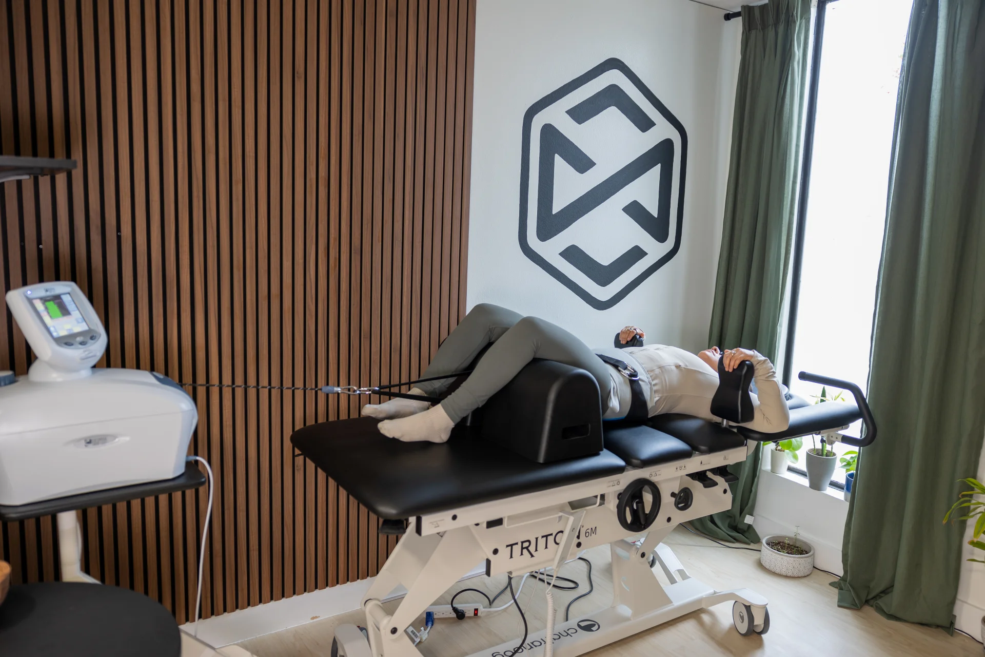 Limitless Chiropractic clinician programming the Triton Chattanooga spinal decompression table for a patient with car accident disc injury in Austin