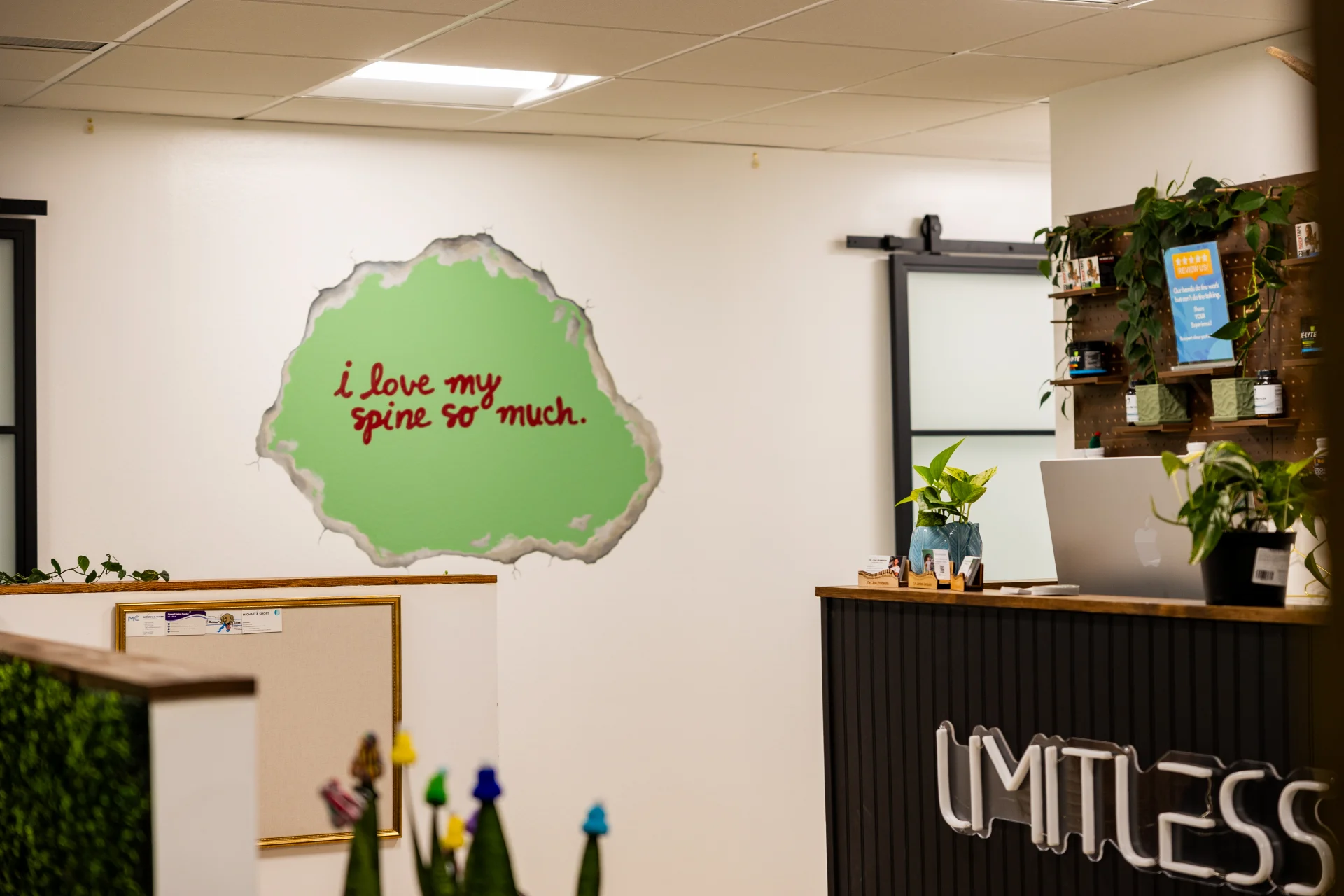 Limitless Chiropractic reception with playful spine wall art
