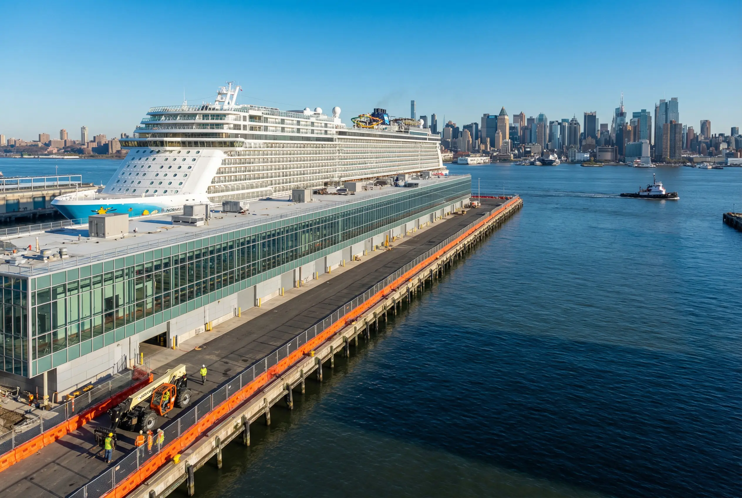 Manhattan Cruise Terminal on Hudson River with cruise ship docked and construction fencing visible during pier modernization project