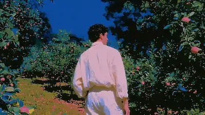 Person in white walking through an orchard with green trees and red apples under a clear blue sky.