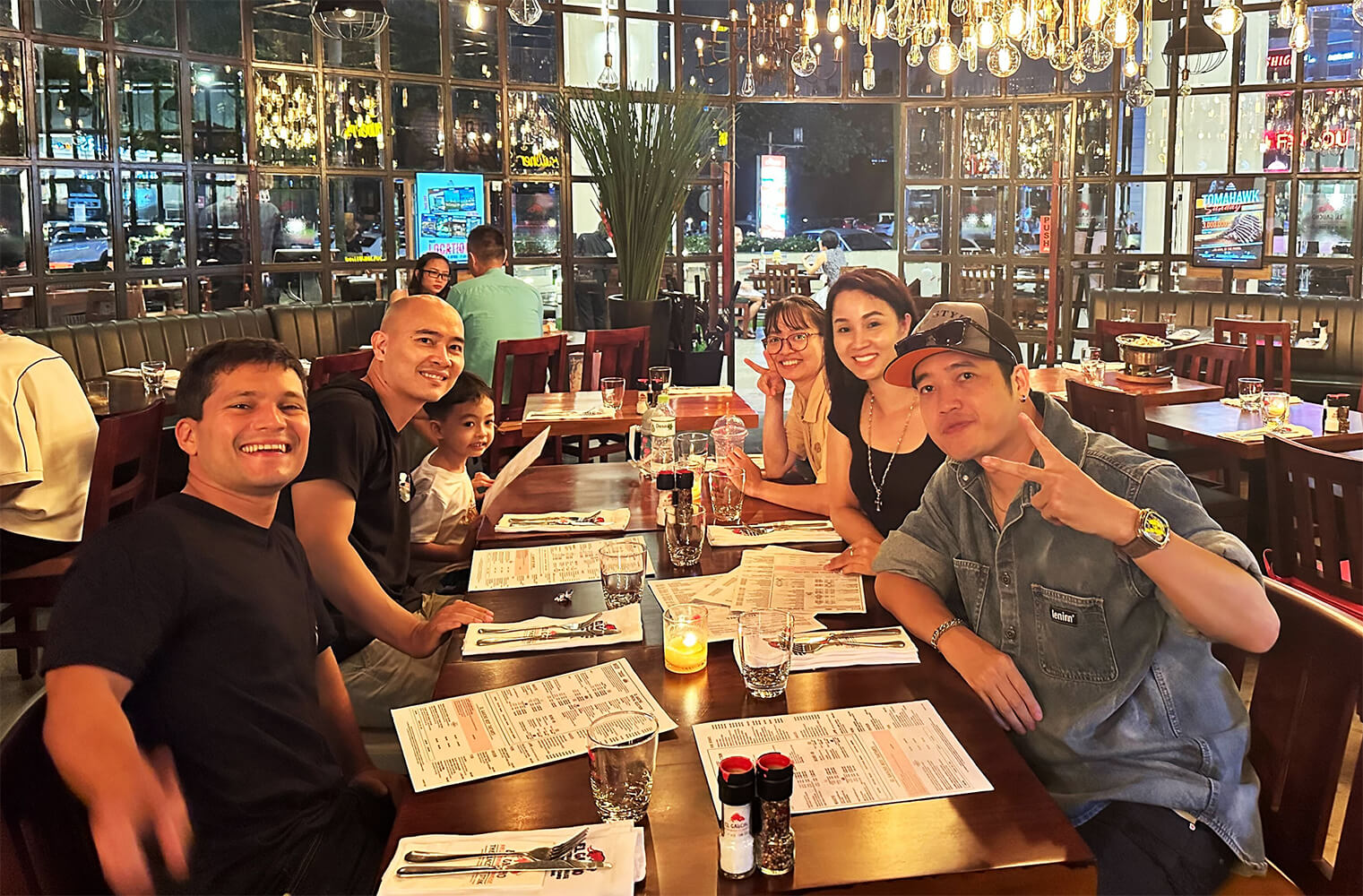 The Konpo team at dinner together, smiling at the camera