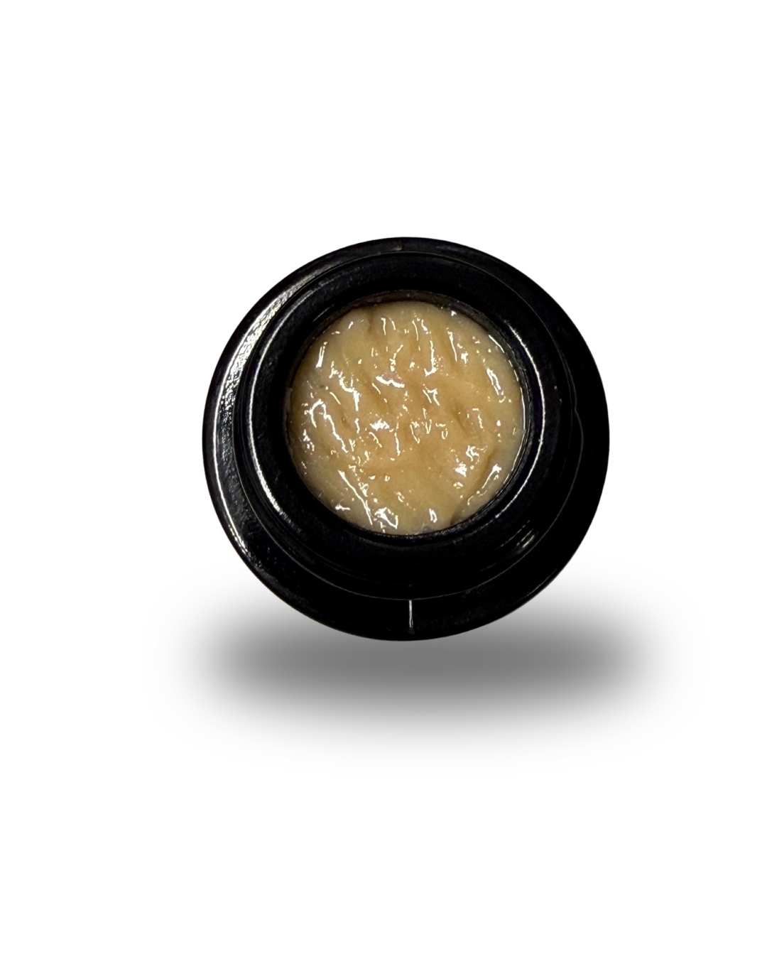 An open jar of Umamii brand Cannabis Concentrate sitting on a white background