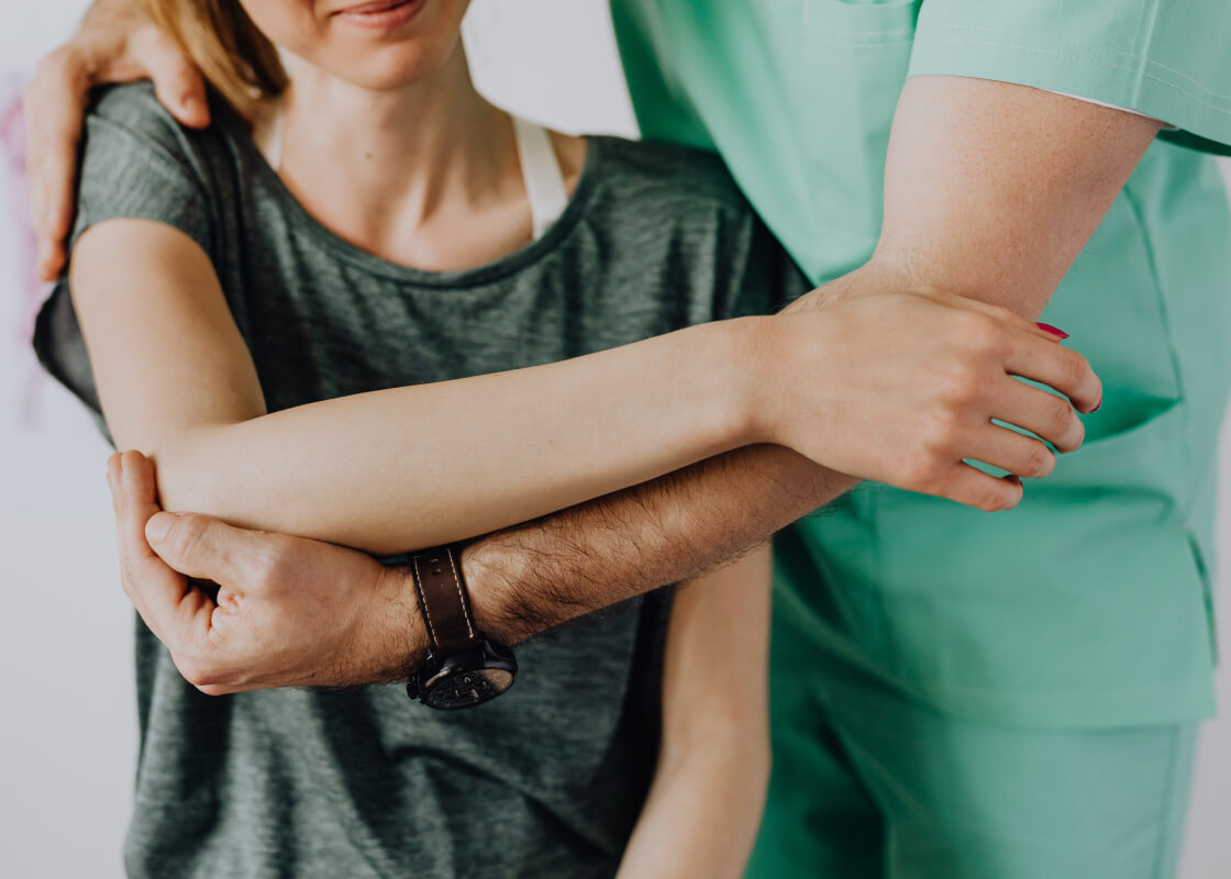 Chiropractor working on a patients shoulder.