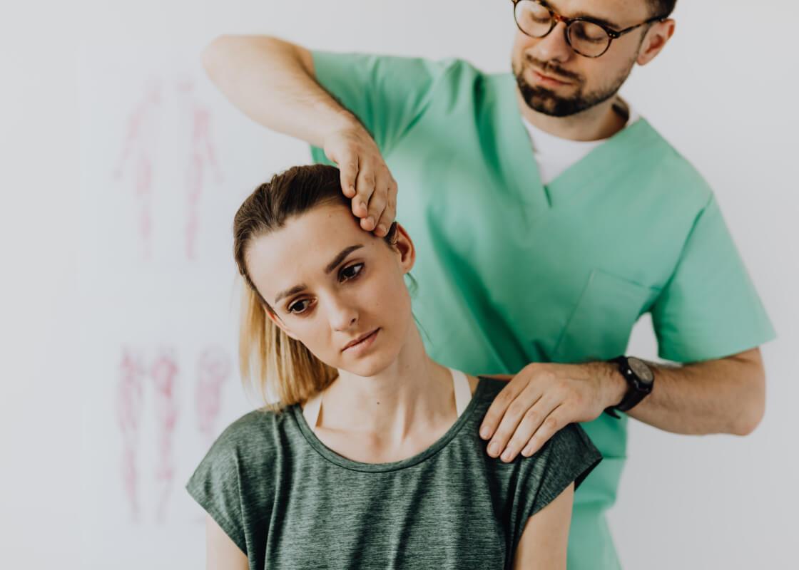 Chiropractor working on a patients neck.