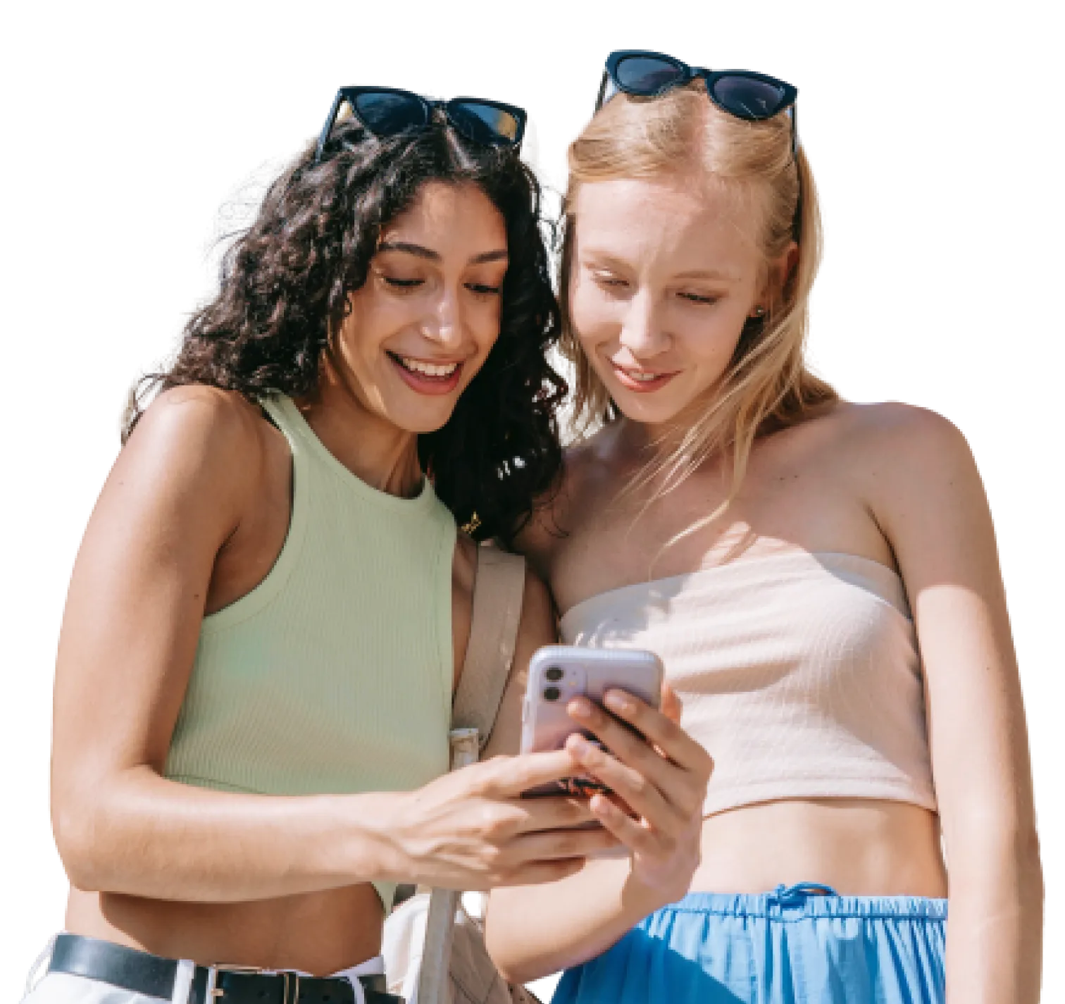 Two young women are looking at a smartphone together.