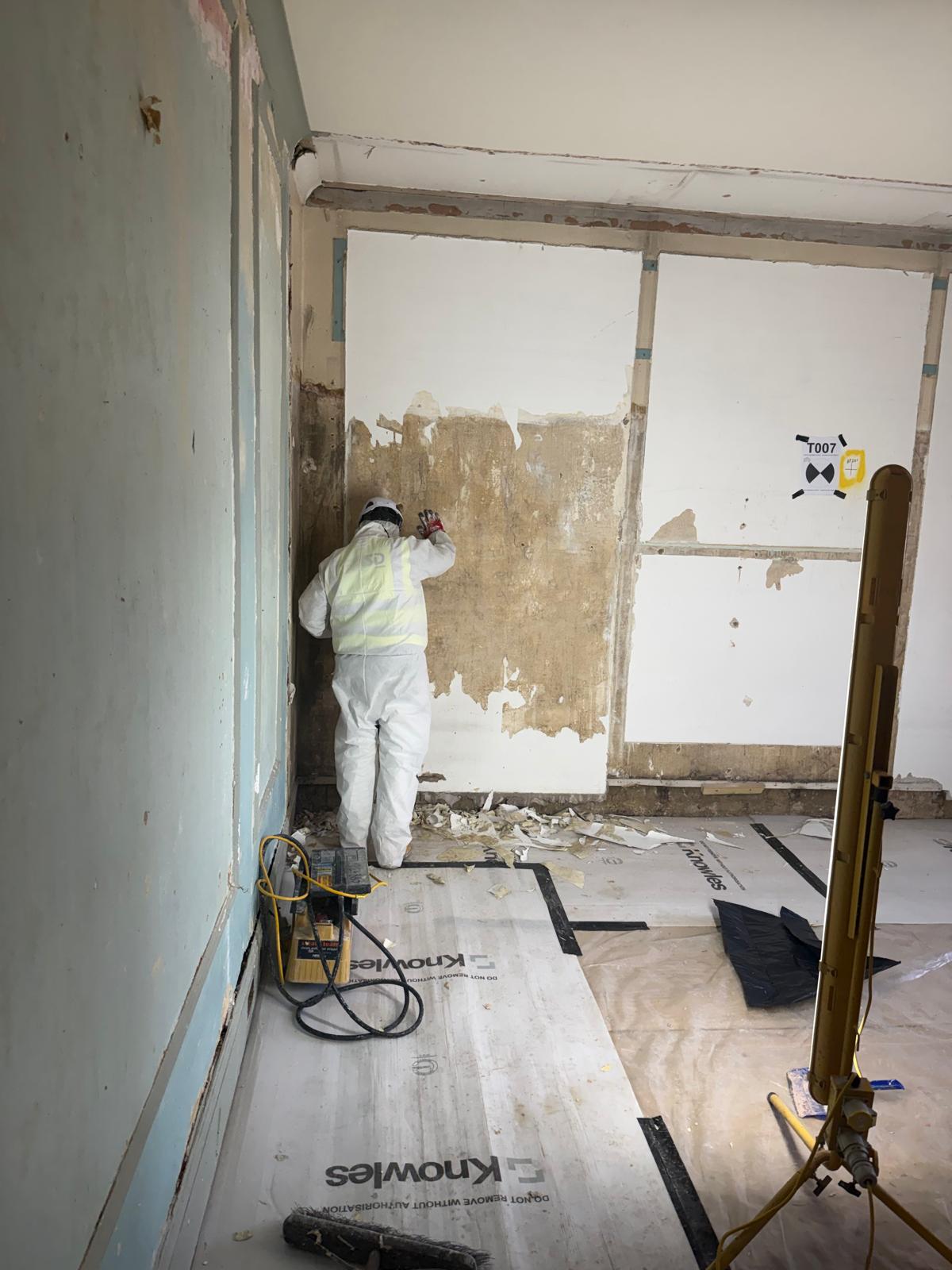 Controlled lead paint removal from a wall, London