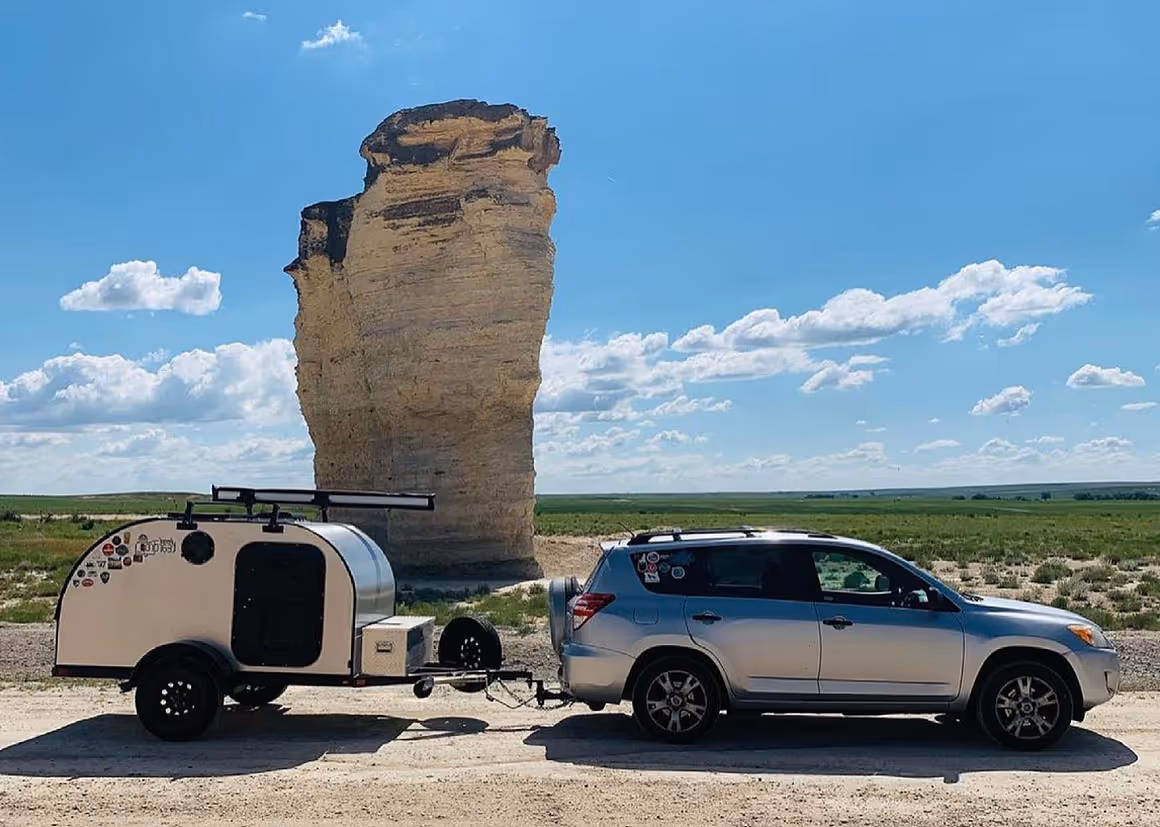 a camper trailer parked in the middle of a field