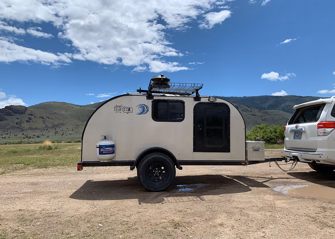 a camper trailer parked in the middle of a field