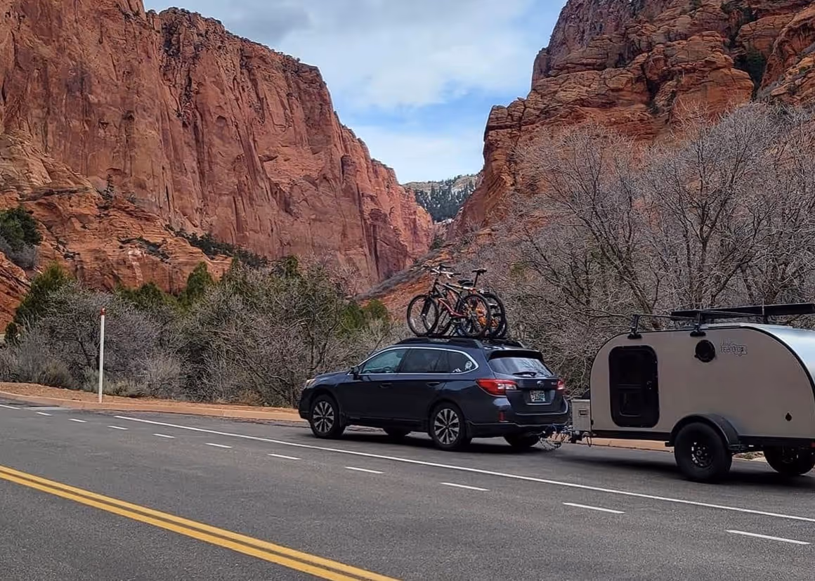 a camper trailer parked in the middle of a field