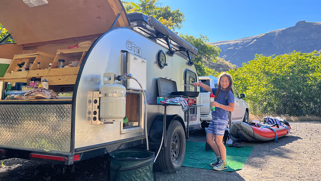 Family Teardrop Trailer with a kid cooking