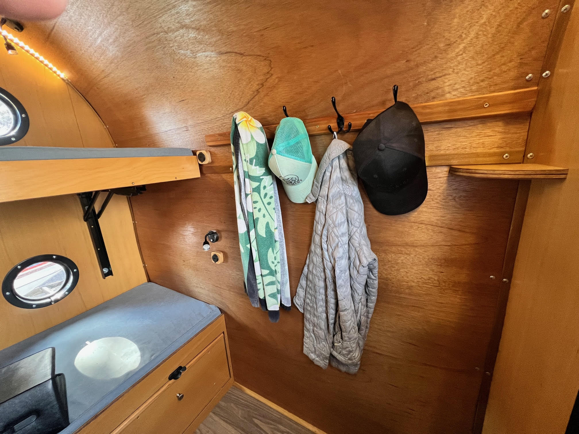 Coat rack for hats, jackets etc... side wall mounted on standard models front right corner mounted on Tallboy 