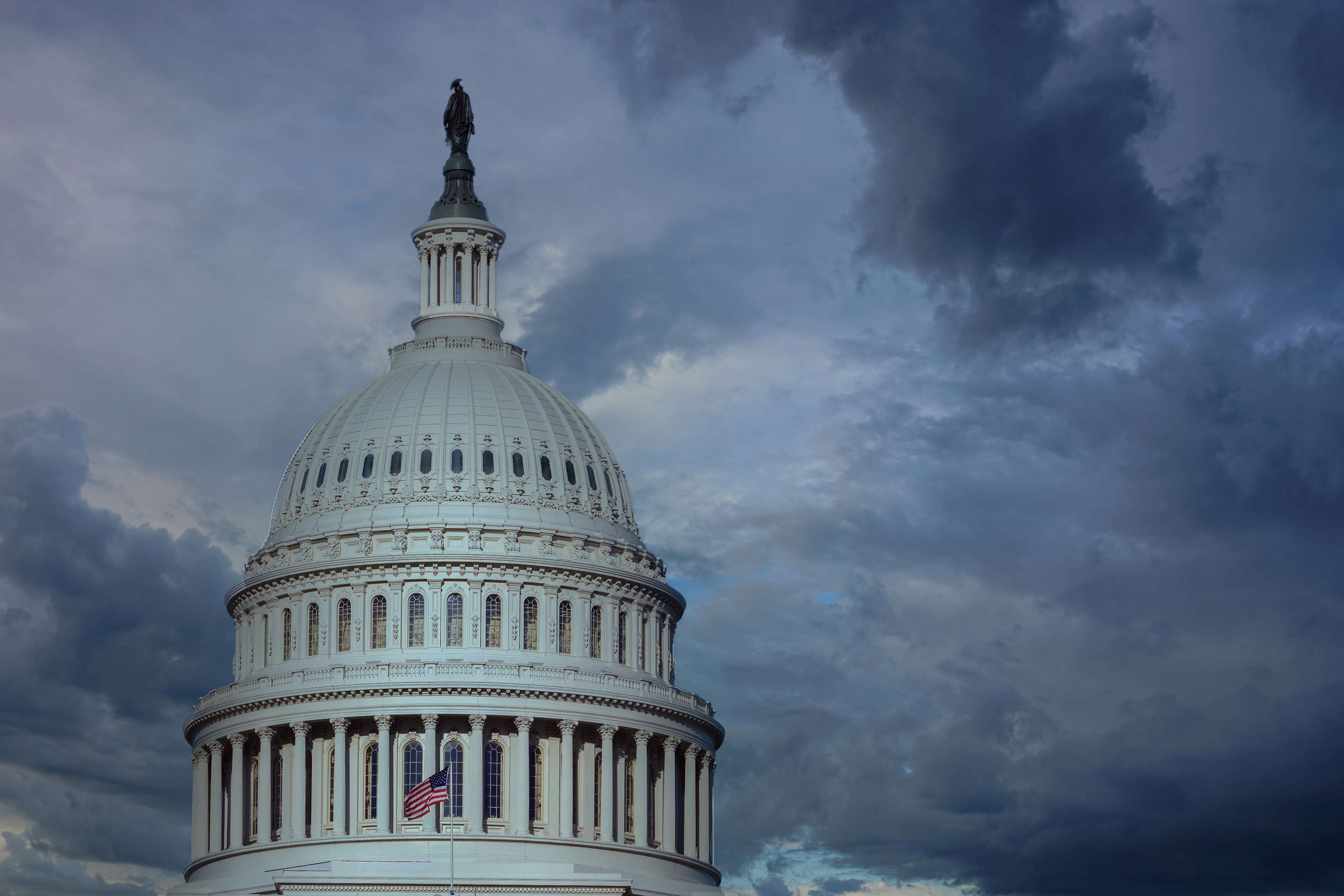 US capital building with a dark and stormy sky in the background