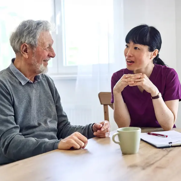 Respite care resident talking to a nurse about their care plan.