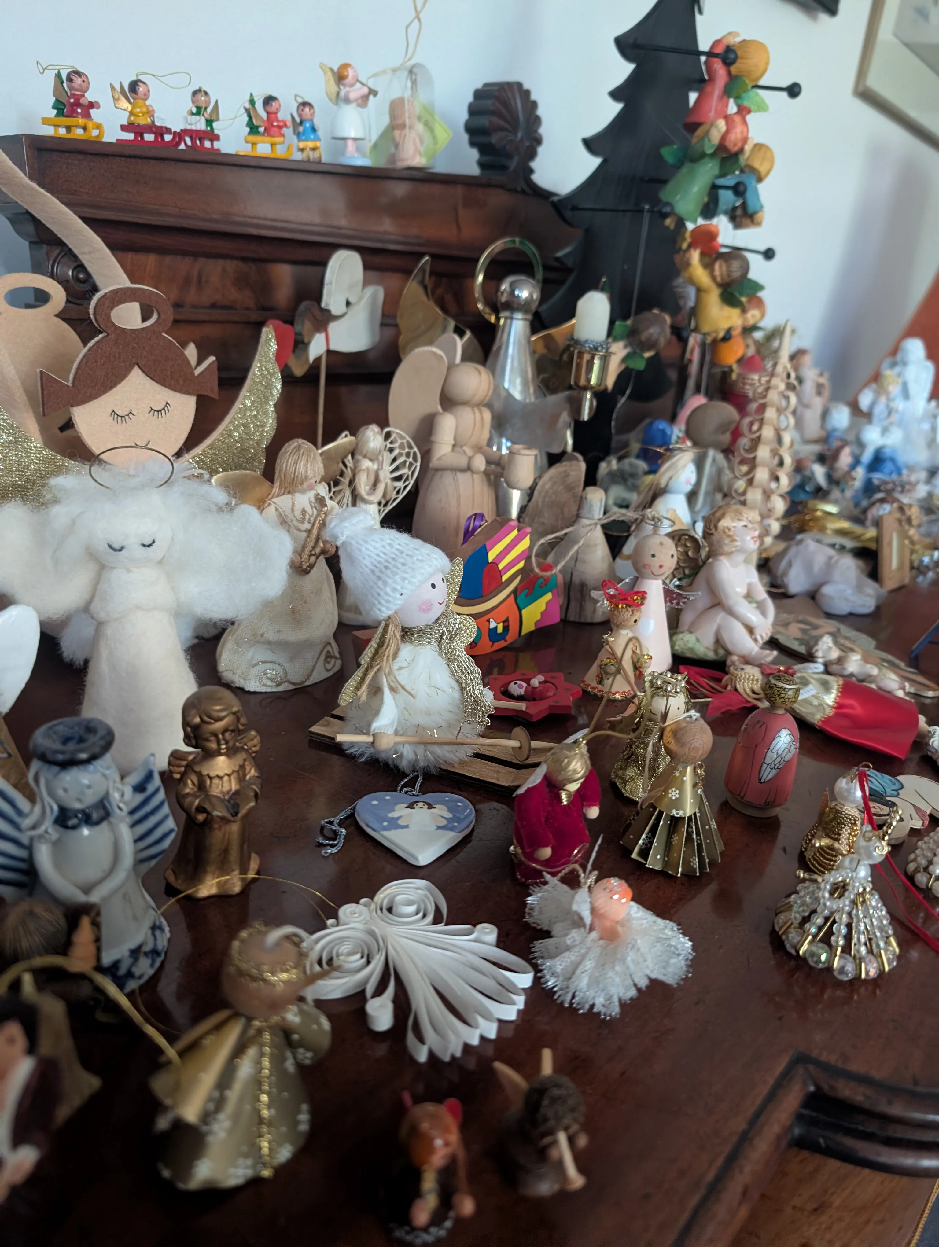 A table filled with more than 100 small angel figurines on display