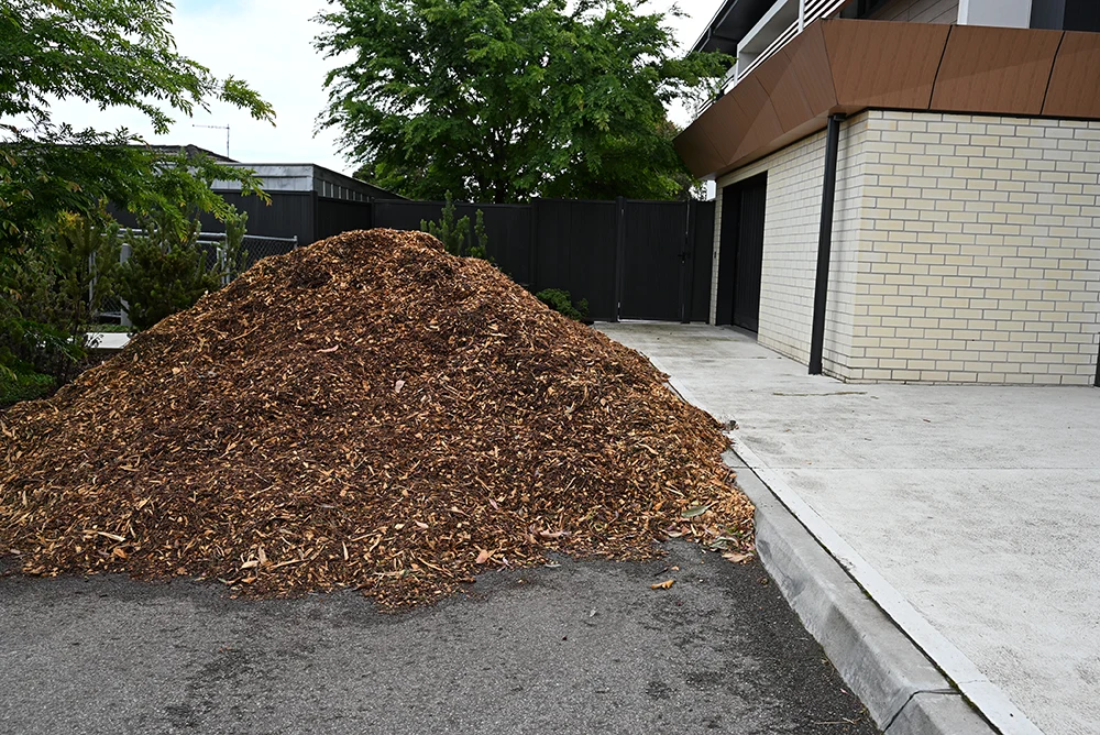 a very large pile of mulch made from trees