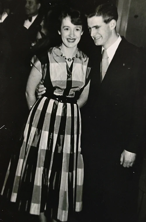 A young happy couple, in a black and white image, smiling