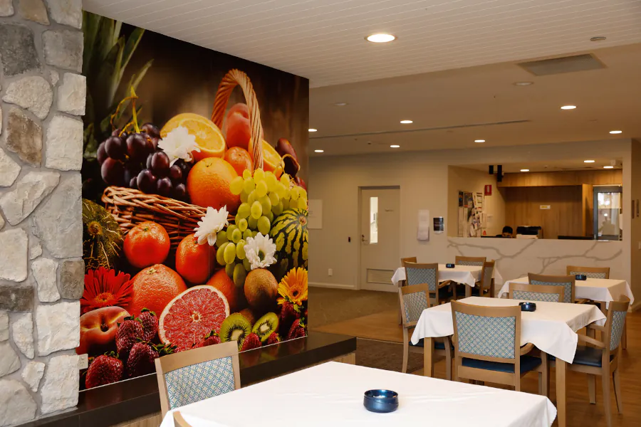 a beautiful and colourful wall mural of a basket full of vegetables in a dining room