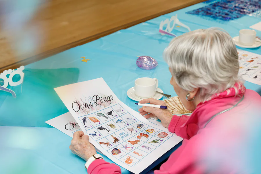 A woman checks out her under the sea bingo cards.