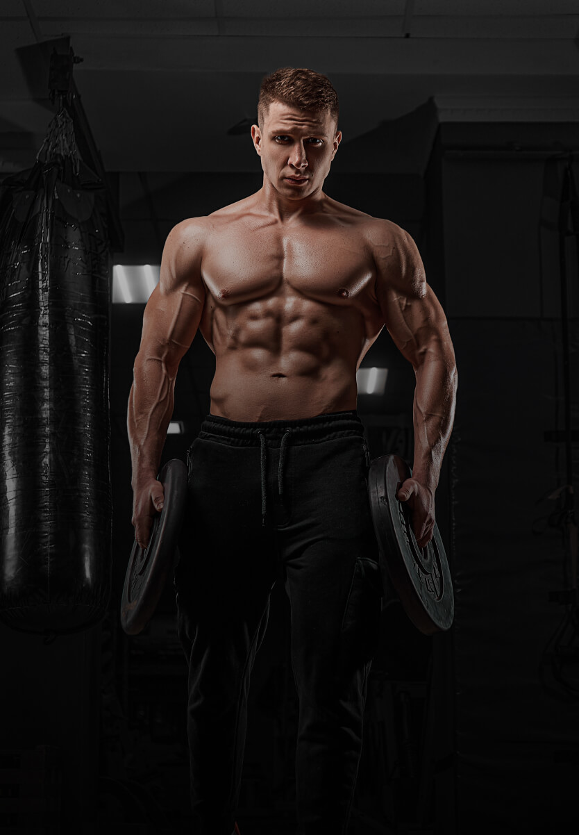 Man holding weight plates in a gym