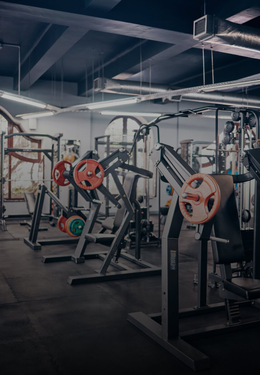 Weight machines and barbells in a gym