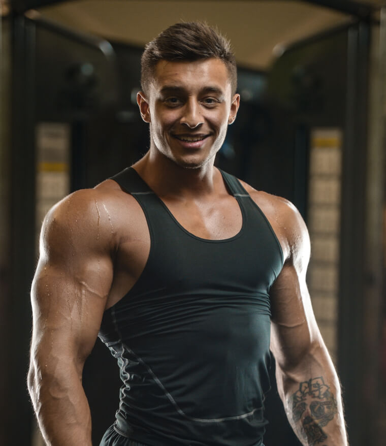 Man in a black sleeveless top in a gym
