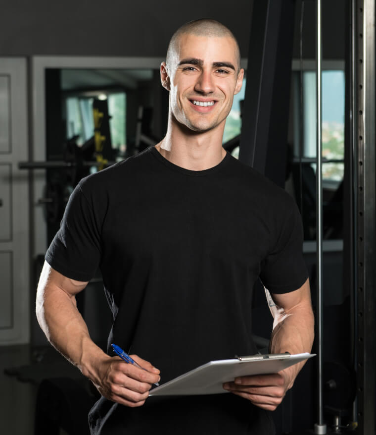 Man holding a clipboard in a gym